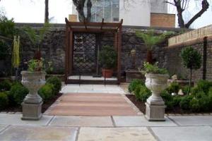 A hardwood iroko path bridges patio and garden. Spotlights are recessed into the path. from project Townhouse Garden