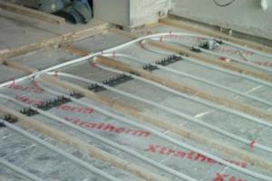 Next, the heating pipes are laid over the tracks. from project Underfloor Heating, Ballsbridge, Dublin 4