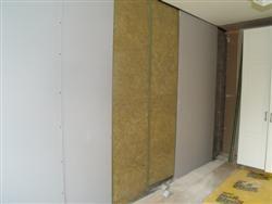 Battens fixed at 600mm centres are infilled with rock wool.  from project RTE Sound Proofing Project