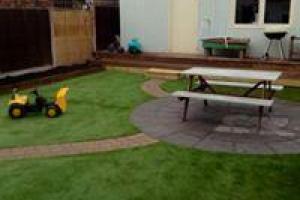 Play area and patio on previously sloping and wet north facing site from project Artificial Grass