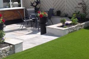 Raised artificial grass and lower sandstone patio area. from project Artificial Grass