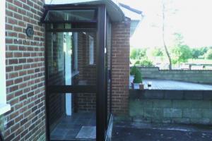 Before, original narrow aluminium porch with sliding doors.  from project Redbrick Porch With French Doors, Coolock, Co. Dublin